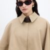 Camel trench coat with cape detail